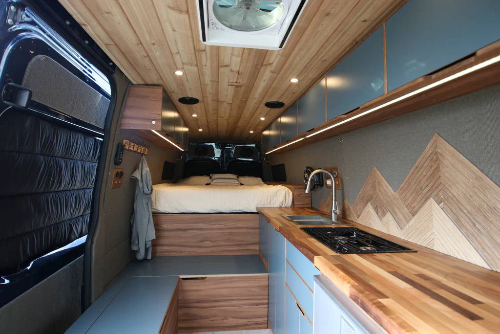 Rack & Roll - Sprinter 144 Van Conversion - Woman and Children Enjoy View from Lofted Bed - The Vansmith
