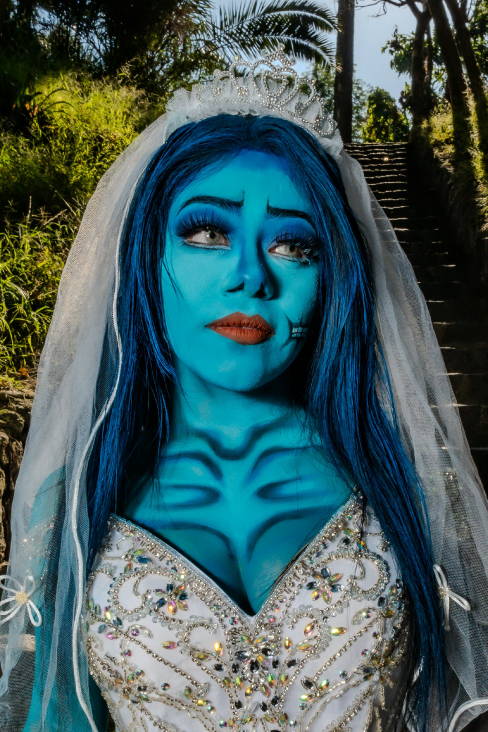 blue woman with blue hair wearing bridal clothing