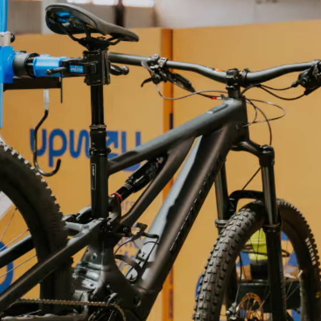 an electric mountain bike on a stand at an upway center