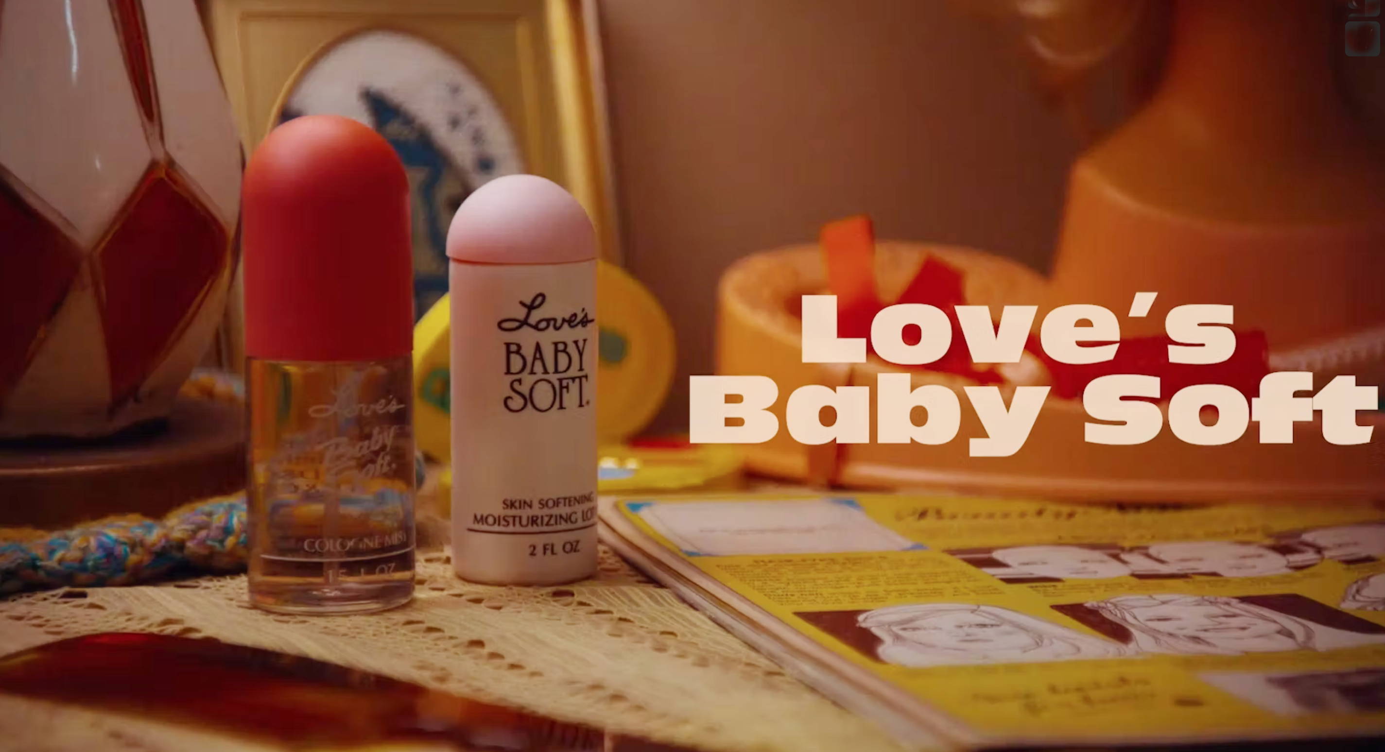 Frist seen of the short movie Love's Baby Soft with 2 samples of vintage Love's Baby Soft bottles on a night stand.