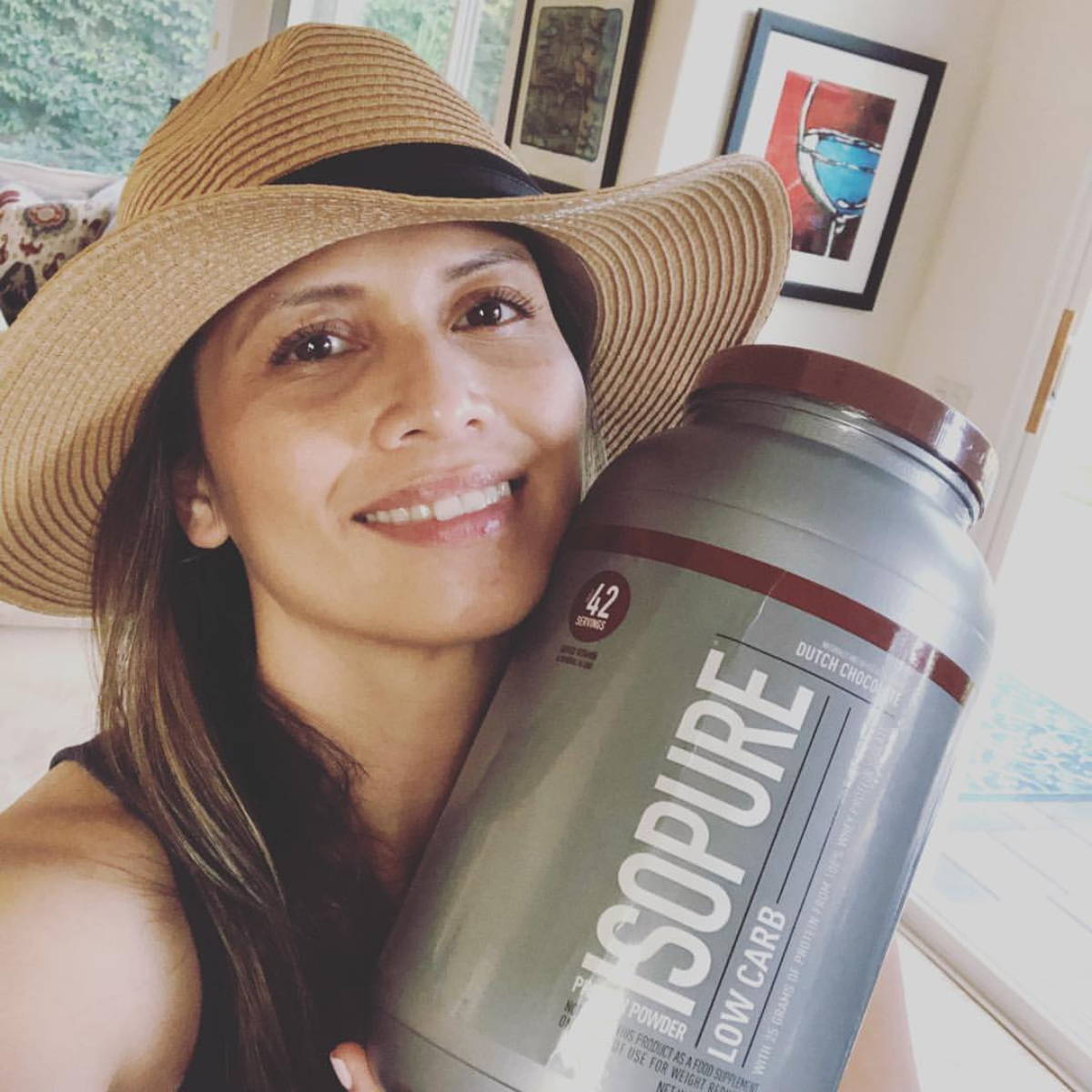 woman athlete shows her bottle of isopure protein