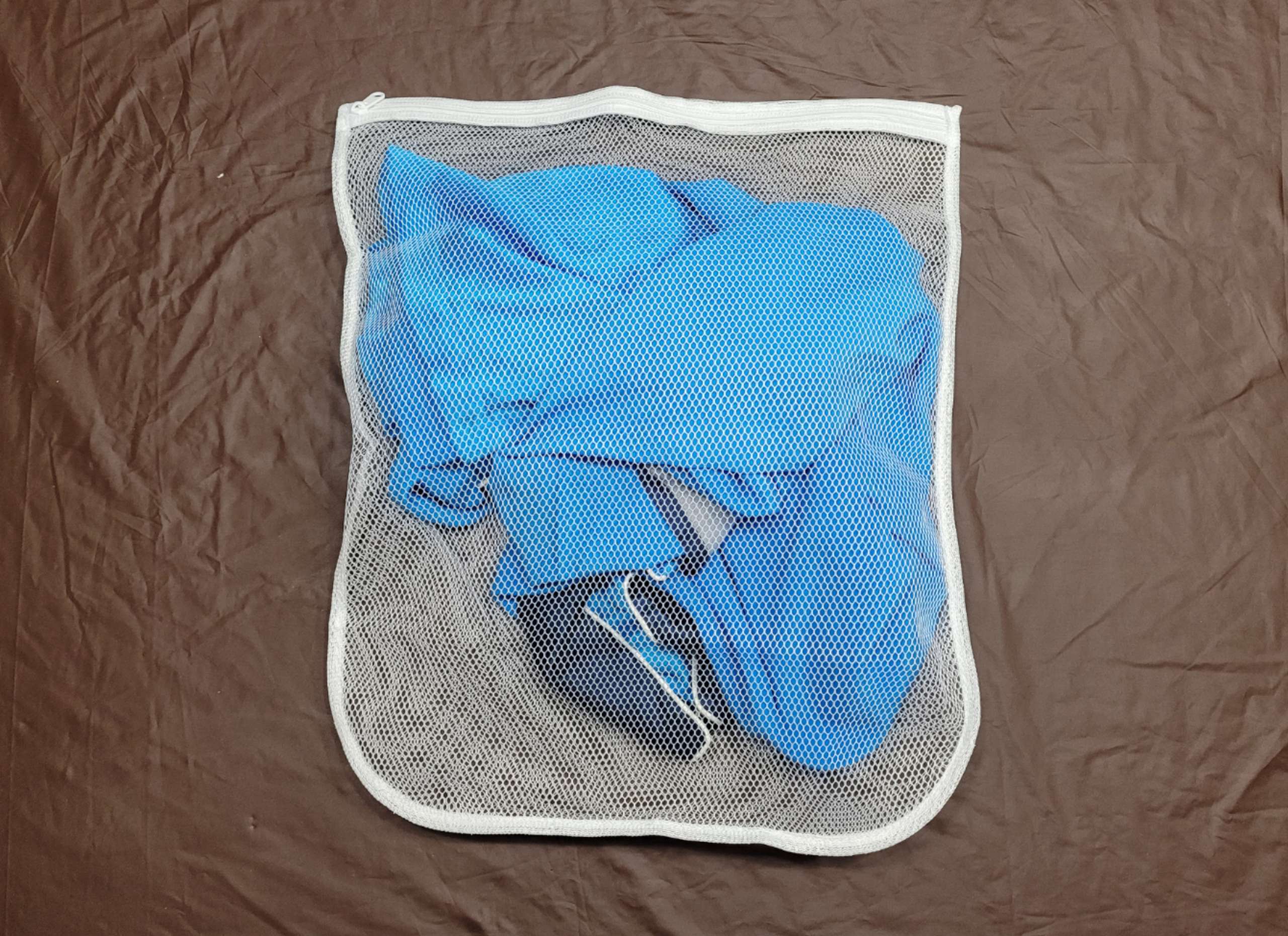 photo of blue satin pajamas in a mesh laundry bag