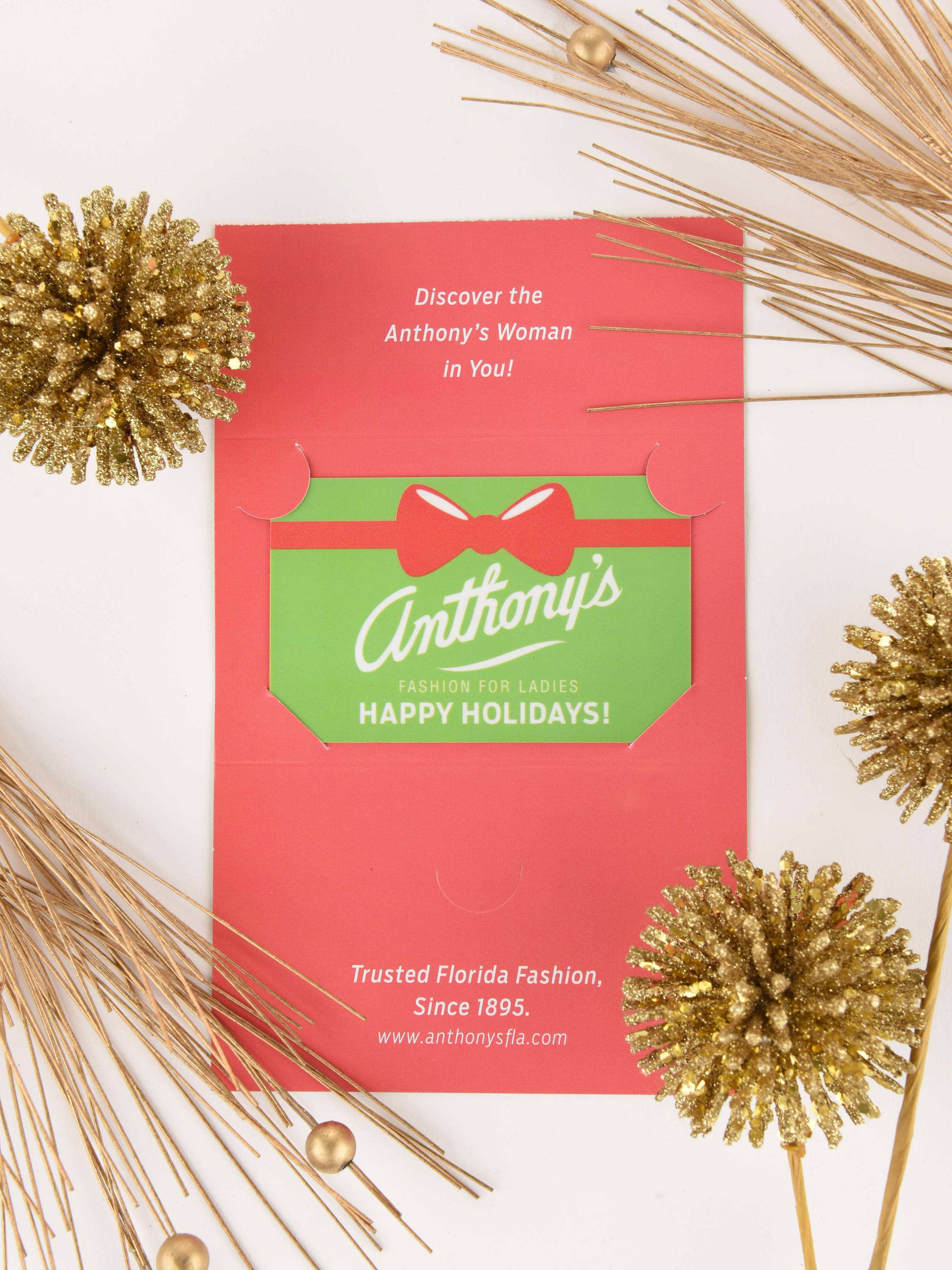 An Anthony's gift card with sparkly gold holiday decorations