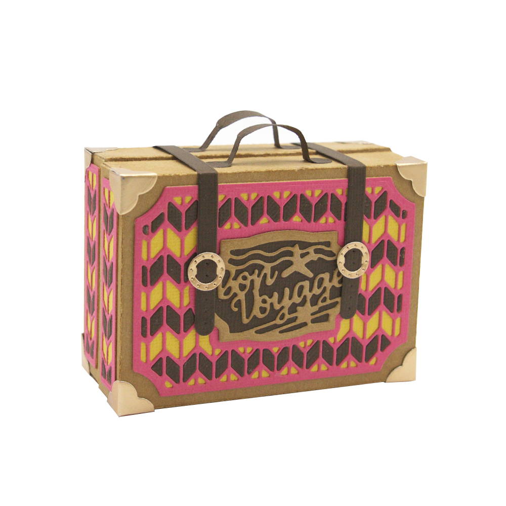 A vibrant handmade suitcase, with Bon Voyage adhered to the front