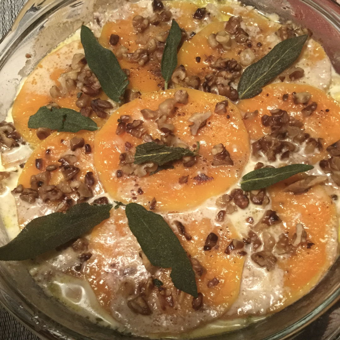 This is a layered butternut and leek gratin with sage and toasted pecans in a creamy Parmesan sauce.