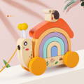Montessori pulling Snail toy with wheels and rainbow.