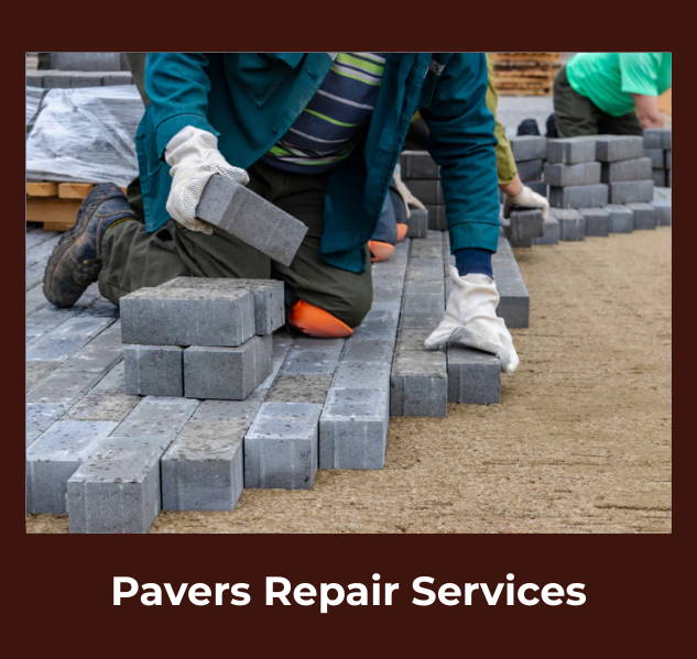 Workers in gloves installing rectangular pavers on a prepared sand base, creating a smooth surface.