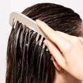 comb brushing through a woman's wet hair