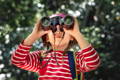 Little boy looking through the binoculars. 