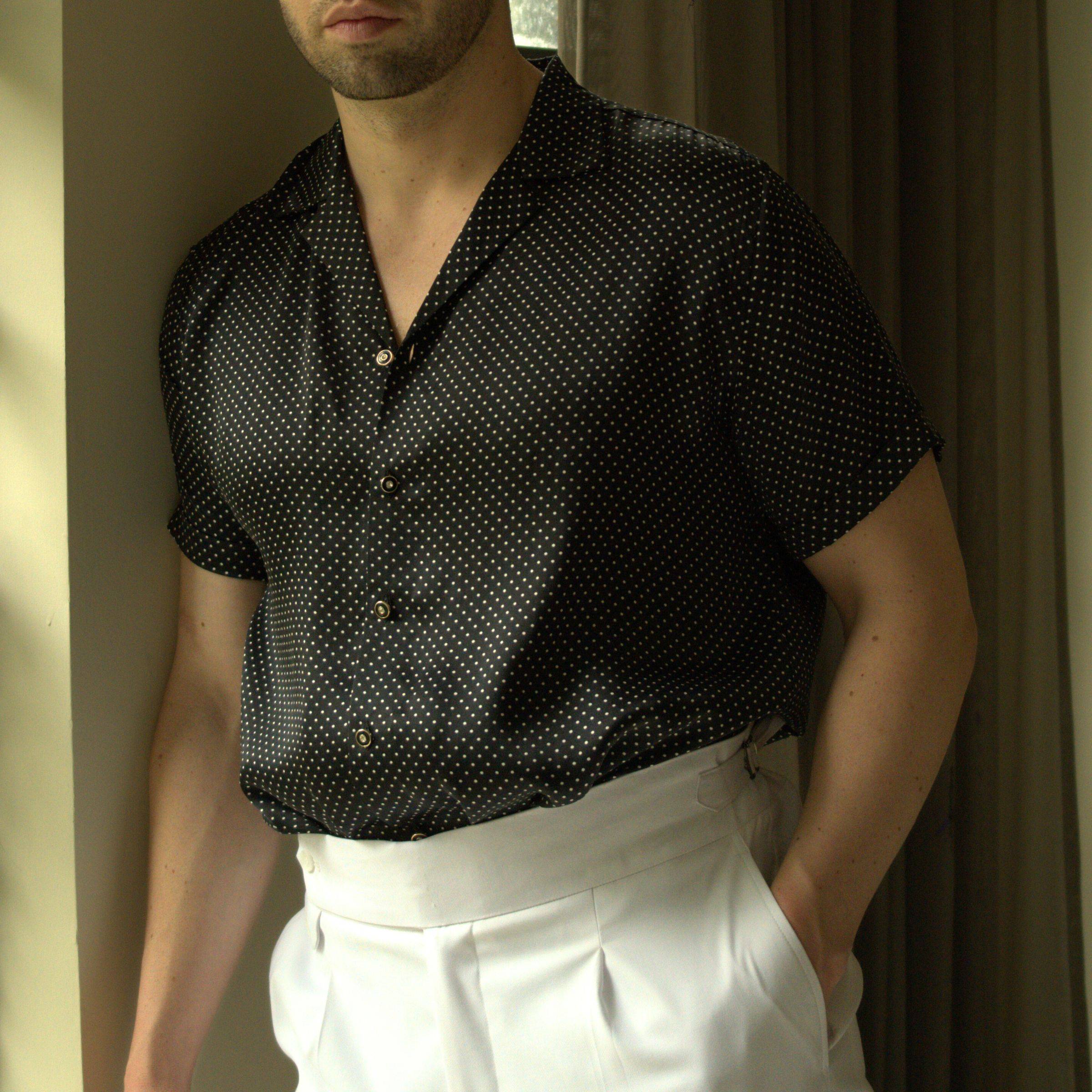 close up image of a male model wearing a short sleeve black dotted silk shirt from 1000 kingdoms
