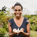smiling lady holding kava chips