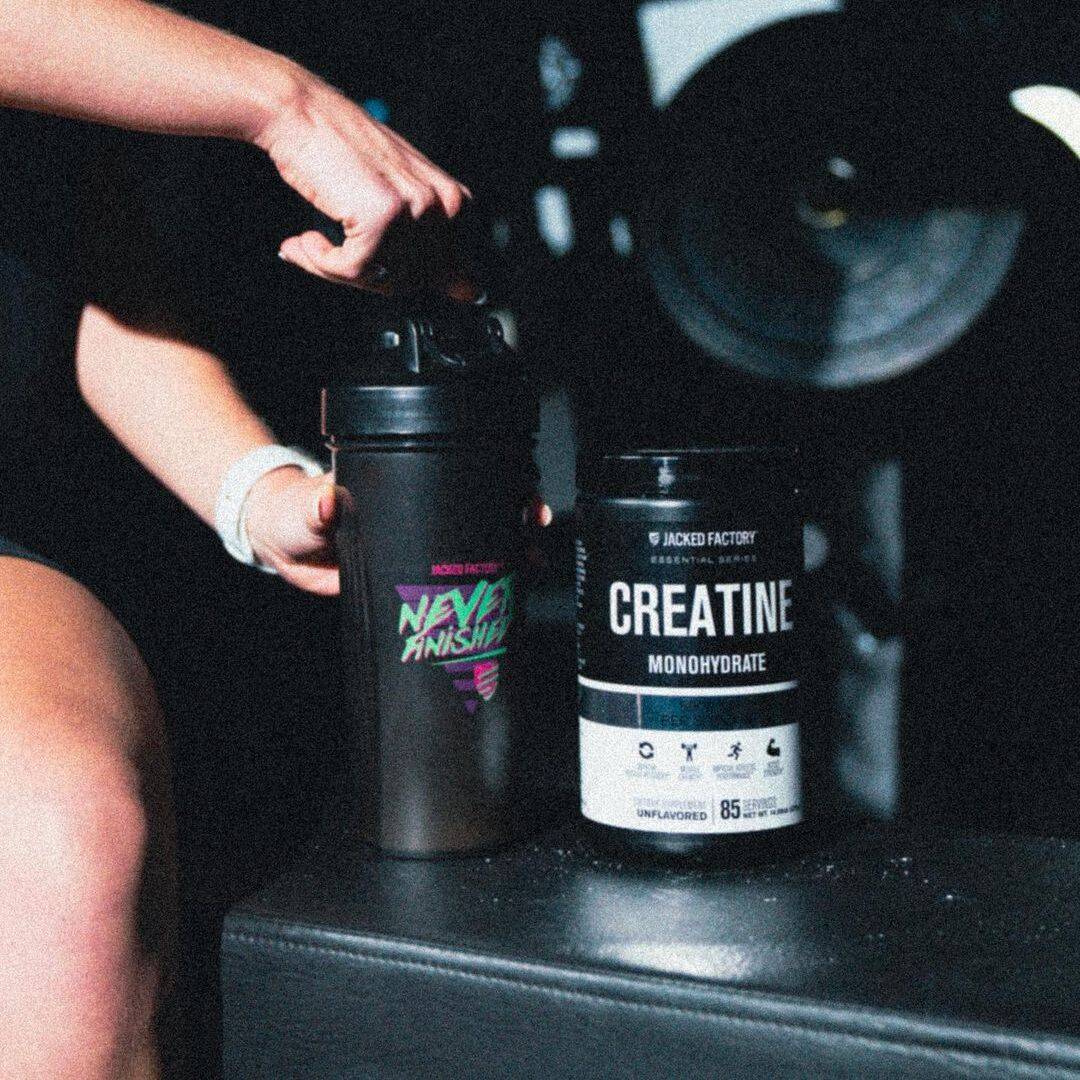 jacked factory Creatine Monohydrate on table near a shaker and female athlete
