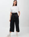 Woman wearing white organic cotton t-shirt and black organic cotton culottes from German sustainable clothing brand Armedangels
