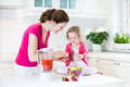 Mother and daughter making a fruit smoothie.