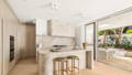 Havit surface mounted downlights over a stone kitchen island and matching hood, with herringbone floors and outdoor alfresco beyond.