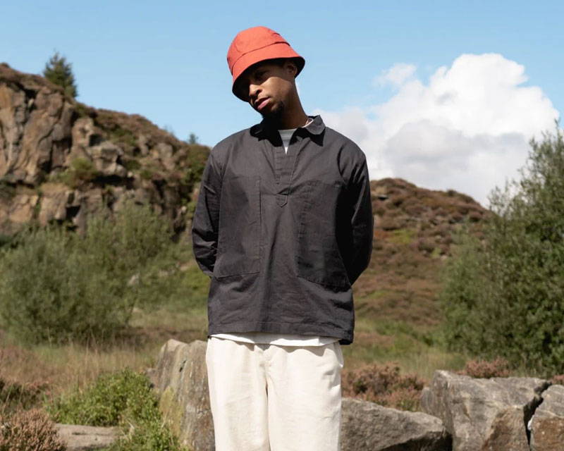 Man wearing waxed cotton organic cotton smock top from sustainable fashion brand Wawwa based in Manchester, UK