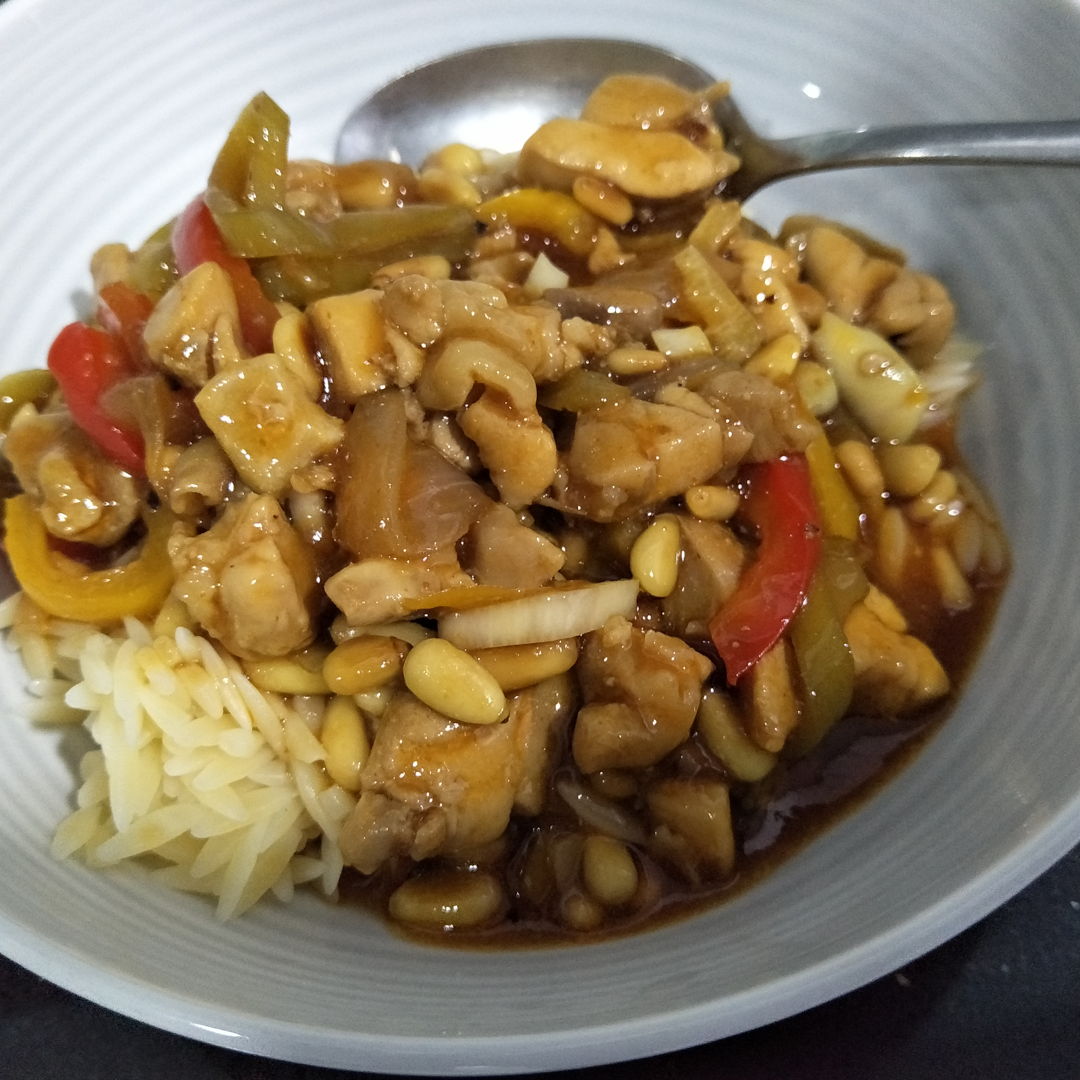 tasty chili chicken in oyster sauce with pine nuts and peppers