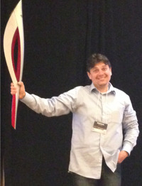 Mikhail Perlov -- seen here carrying an actual Olympic torch: We needed scalability like never before. That is why we put everything in the Cloud.
