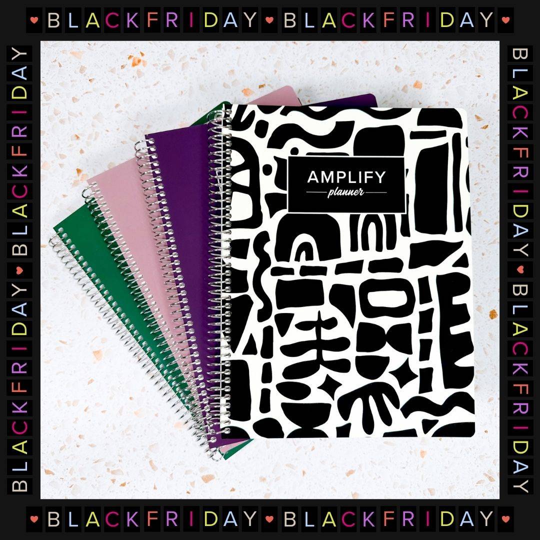 stack of undated daily amplify planners with black friday frame