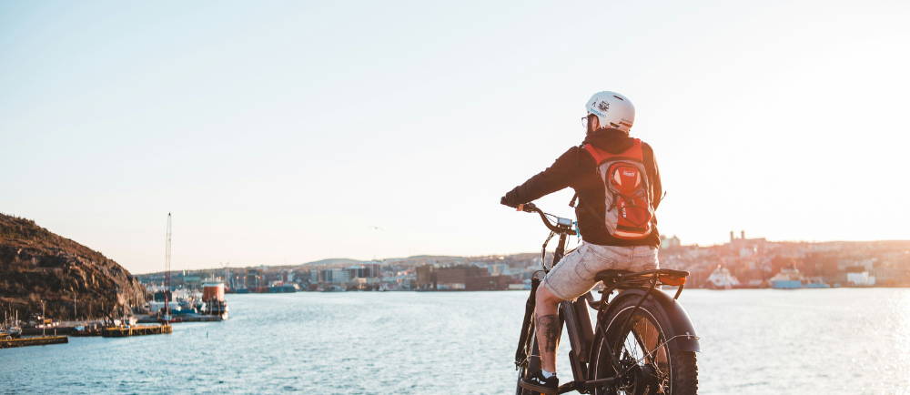 a man overlooking the water while on a Himiway e-Bike