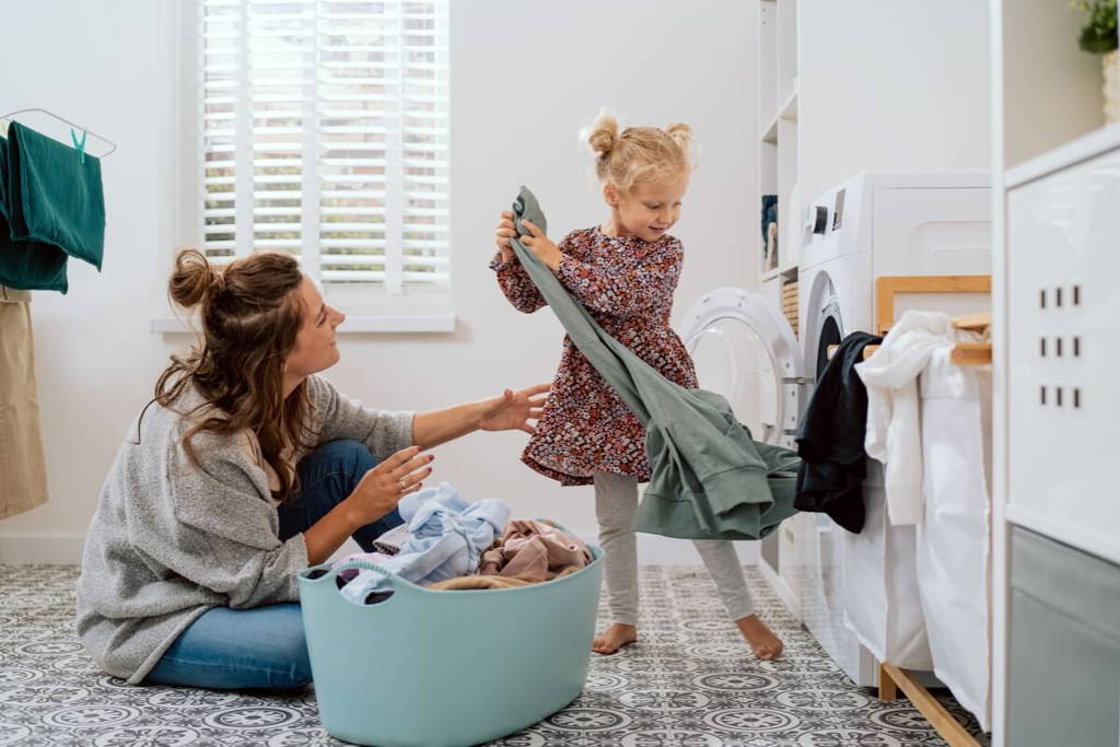 Mother and daughter doing laundry together.