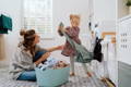 Mother and daughter doing laundry together.