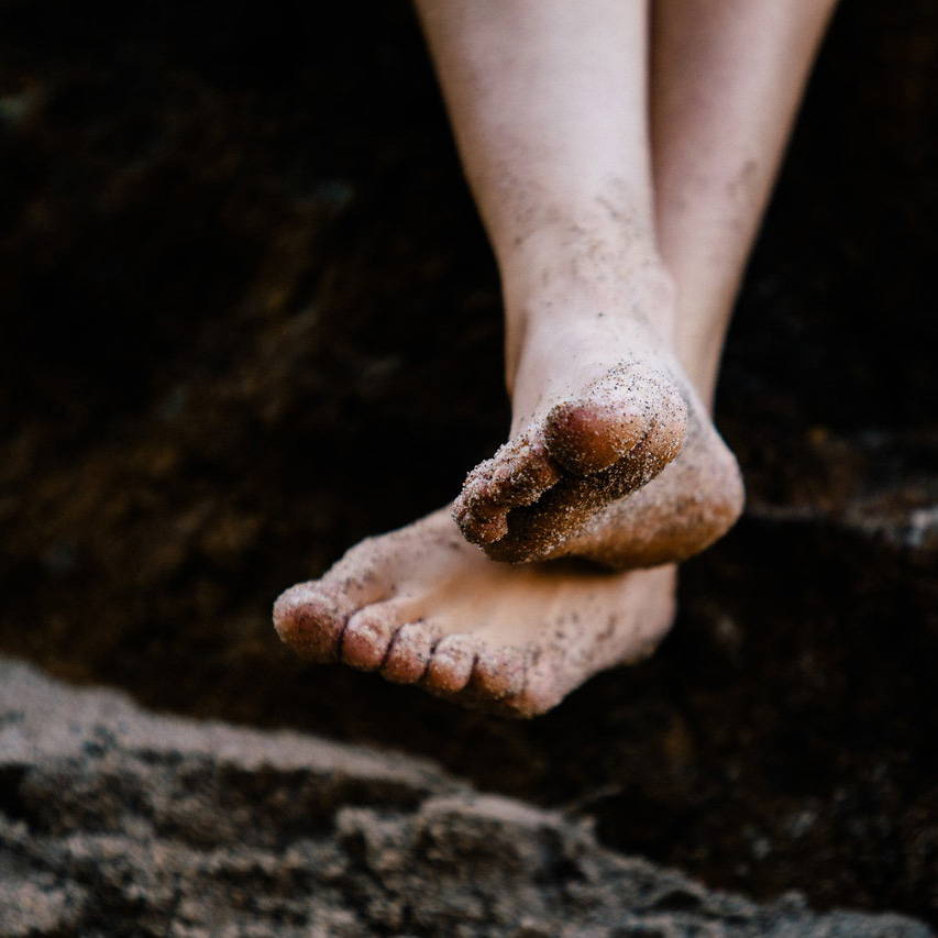 feet sand beach earthing grounding