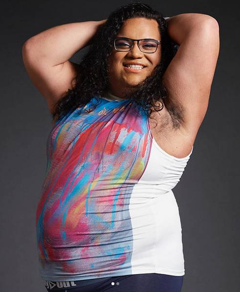 Nonbinary plus-size model Derrick wears Play Out gender equal muscle T that says United in Love.