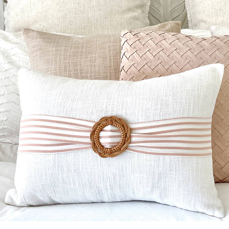 Farmhouse cushion featuring a rattan buckle with pink and white stripe sash, a lovely accent cushions for a traditional farmhouse style home.