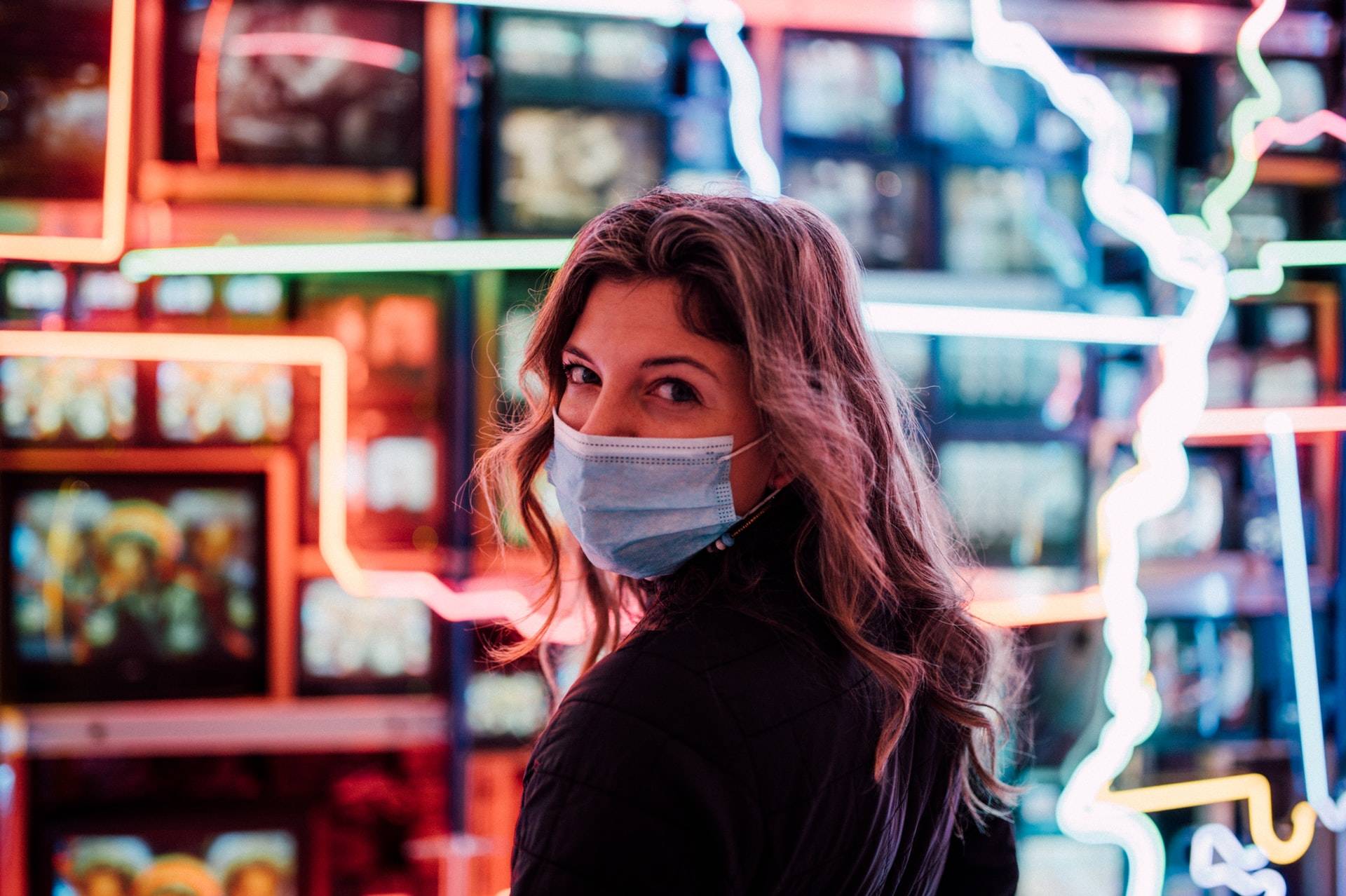 woman with medical mask looking back over her shoulder