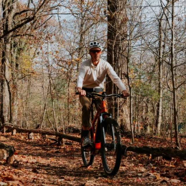 mountain biker riding in an autumnal forest