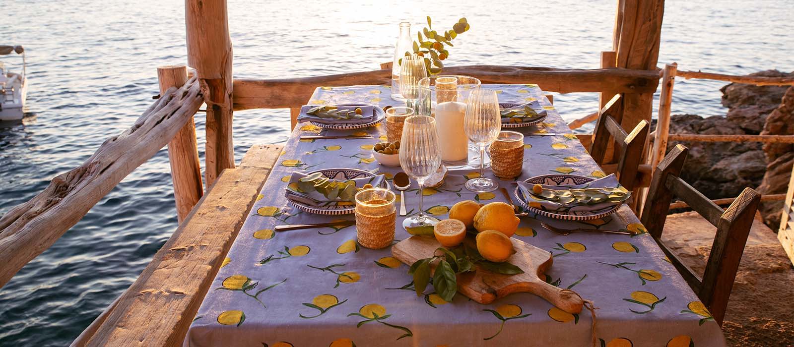 Lemon linen tablecloth shot on a beach in Ibiza