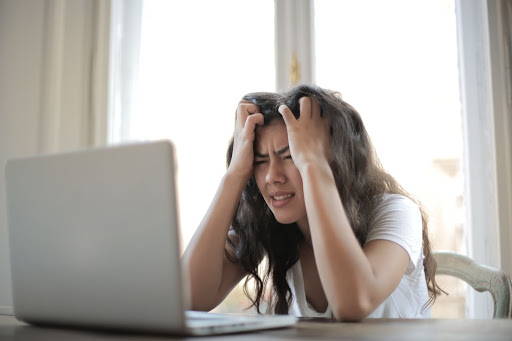 Girl stressed out while doing work -Photo by Andrea Piacquadio from Pexels