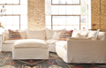 Large slipcovered sectional and ottoman
