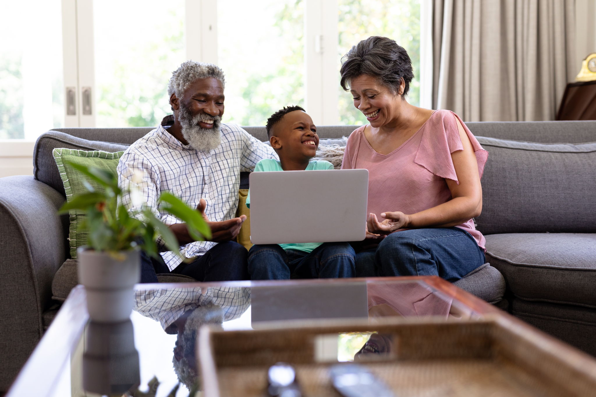 grandparents with child on a lap top