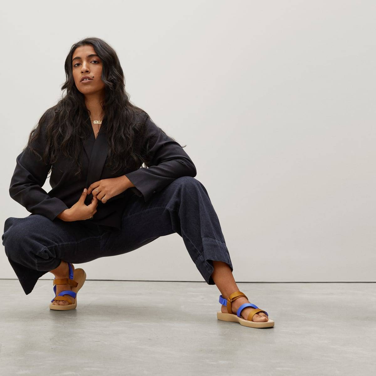 A model wears Everlane sandals made from recycled plastic bottles