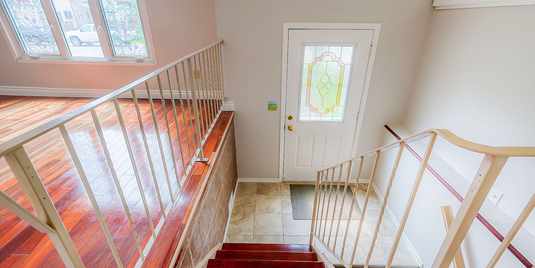 staircase featuring hardwood floors and plenty of natural light