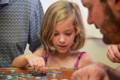 Little girl playing with puzzles. 