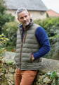 Mid layer gilet being worn over a jumper with chinos