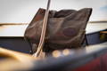 close up of and old no. 7 canoe pack in a canoe with a paddle resting against it.
