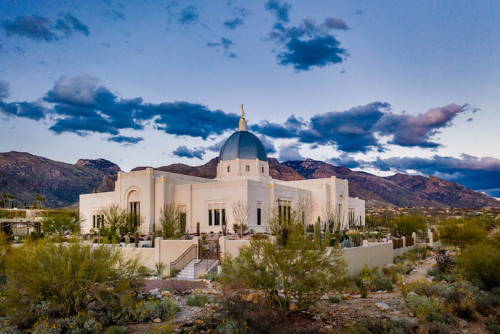 Tucson temple surrounded by a blue sky and a desert landscape.