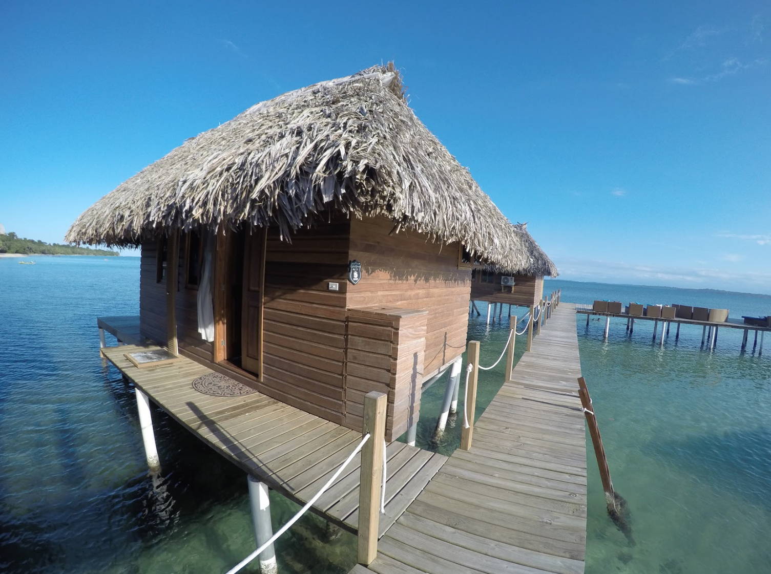 A floating hut with a straw roof in the sea in panama