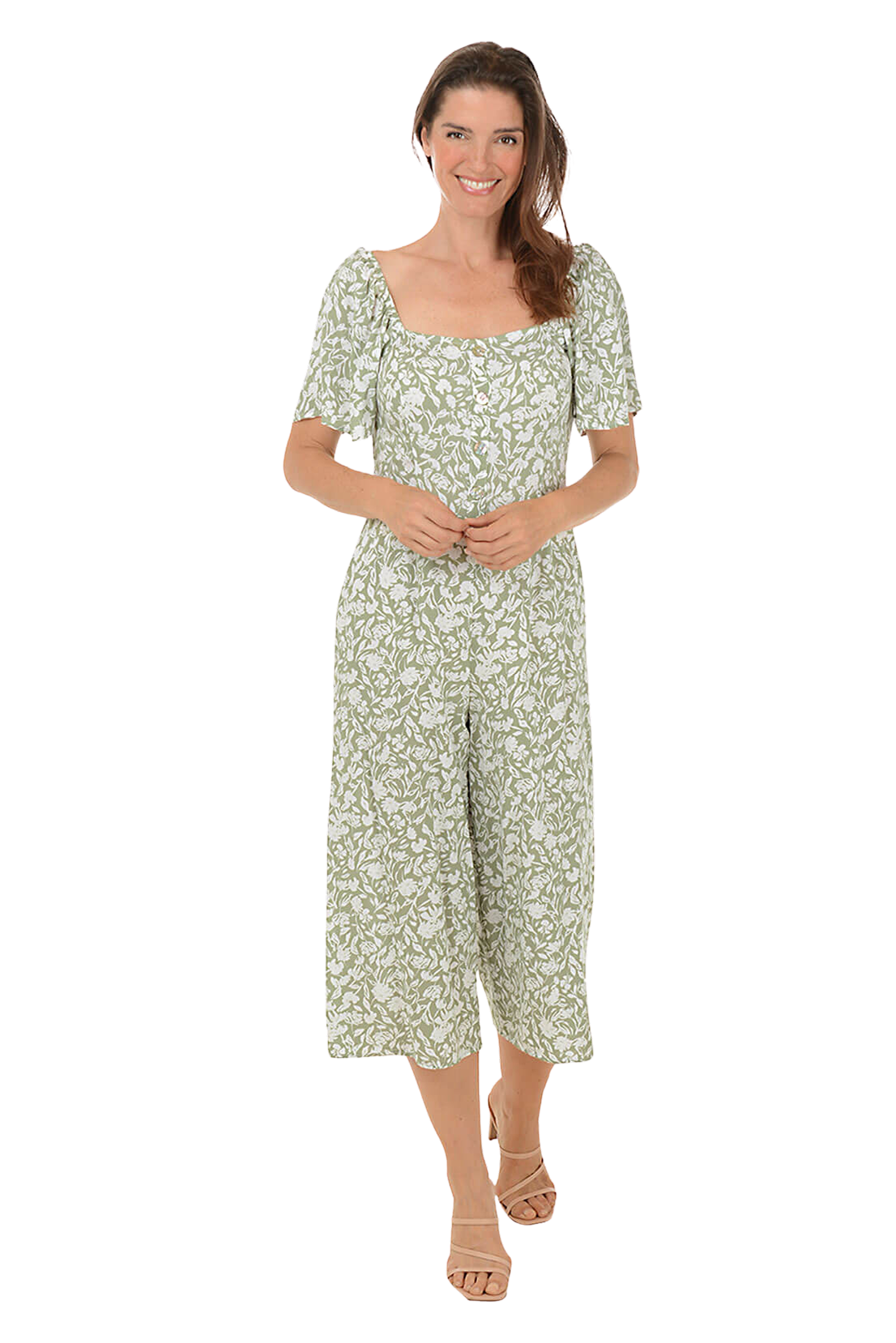 A woman wears an olive floral square neck jumpsuit.