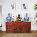 An oriental interior with a hand painted antique Chinese red lacquer sideboard and the art of Jazzy Westinghouse