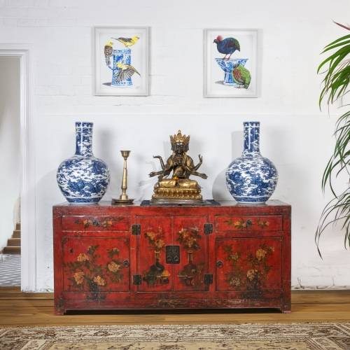 An oriental interior with a hand painted antique Chinese red lacquer sideboard and the art of Jazzy Westinghouse