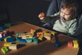 Baby playing with wooden block toys.