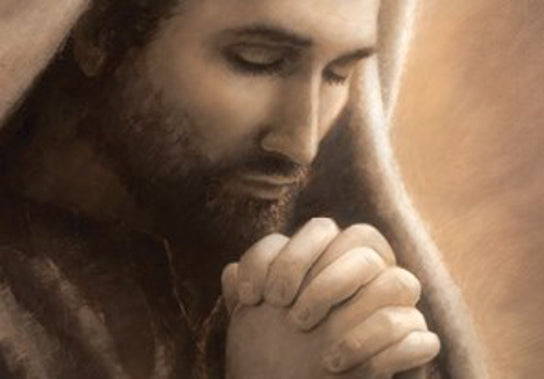 Sepia toned portait of of Jesus with his hands clasped in prayer. 