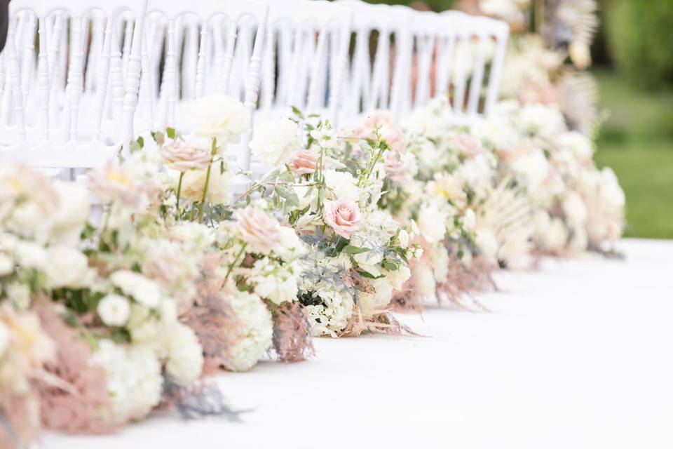 Pastel flower arrangements along ceremony aisle
