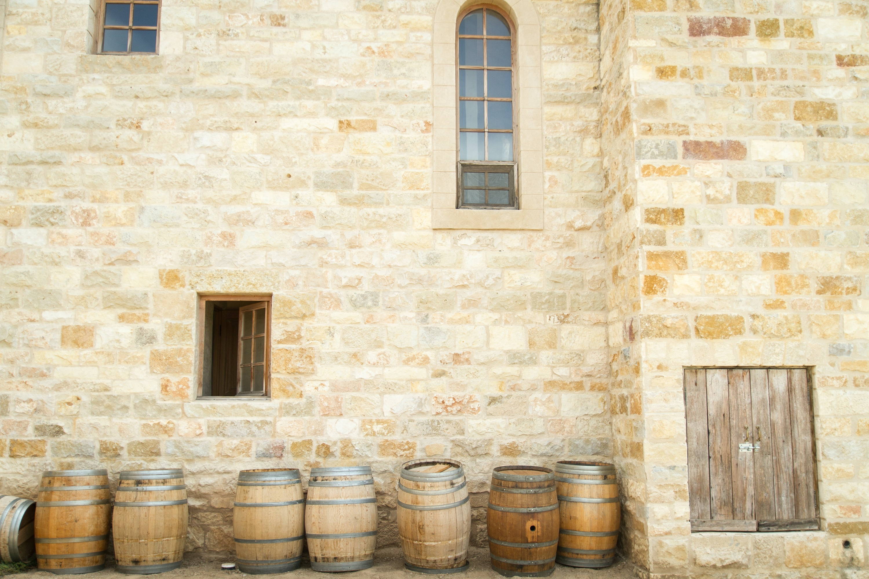 Side view of traditional Spanish wall side with wine barrels. 