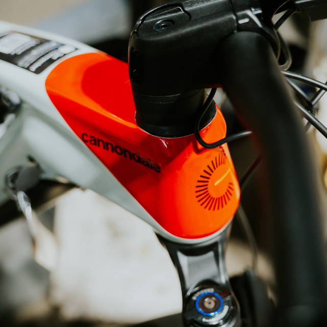 a white and red Cannondale Moterra electric mountain bike